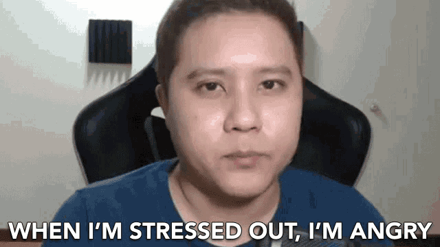 a man is sitting in a chair with the words when i 'm stressed out i 'm angry