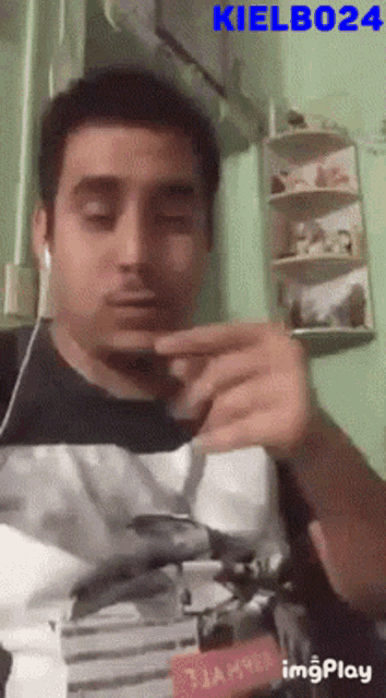 a man wearing headphones and a shirt with a picture of a dolphin on it