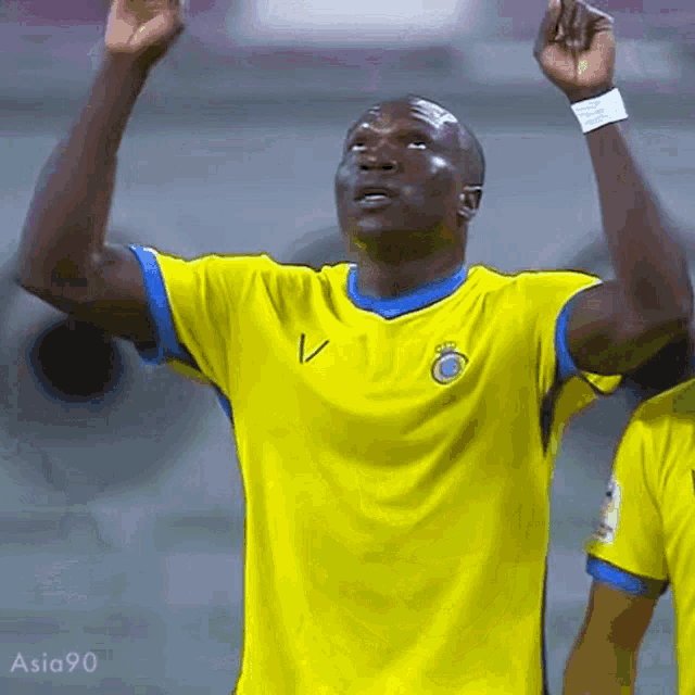 a man in a yellow and blue shirt with the letter v on it