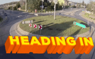 a roundabout with the words heading in in yellow