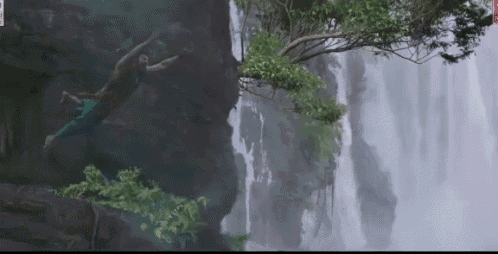 a waterfall is surrounded by trees and rocks and has a watermark that says ' sd ' on it