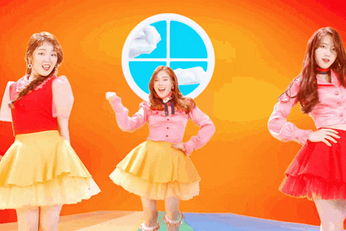 three girls are dancing in front of a window with a circle in the middle
