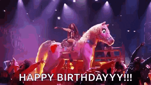 a woman is riding on the back of a stuffed horse on stage .