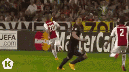 a soccer game is being played in front of a mastercard ad