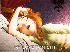 anna from frozen is sleeping on a bed with her eyes closed and her hand on her head .