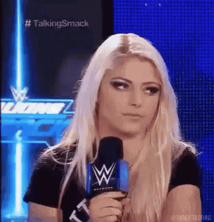 a woman is holding a microphone and looking at the camera while wearing a black shirt .