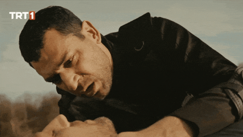 a man laying on the ground with trt1 on the bottom