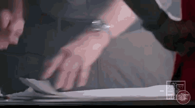 a person is holding a piece of paper in their hands .