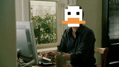 a man is typing on a computer with a pixelated duck face on his face