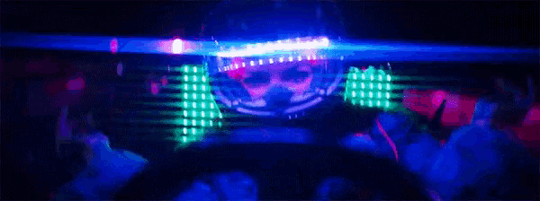 a person is dancing in a dark room with blue lights behind them .