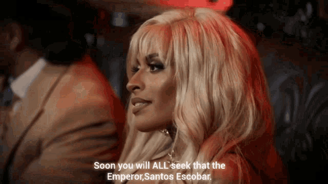 a woman with blonde hair is talking about the emperor santos escobar