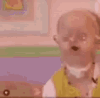 a blurry picture of a child wearing headphones and a yellow jacket .
