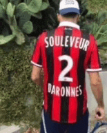 a man is wearing a red and black striped shirt with the number 2 on it