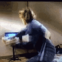 a blurry picture of a person sitting in front of a computer