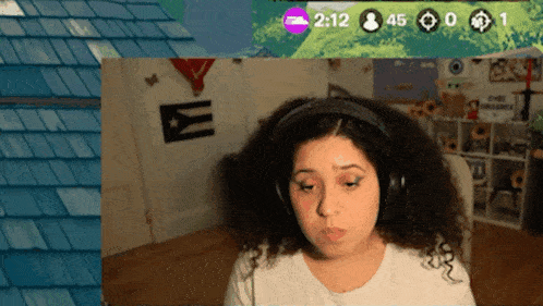 a woman wearing headphones looks at a screen that says 2:12 on it