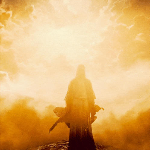 a silhouette of a man standing in front of a bright light