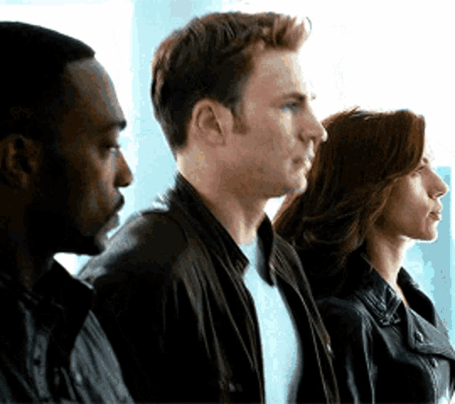 a man and a woman are standing next to each other .