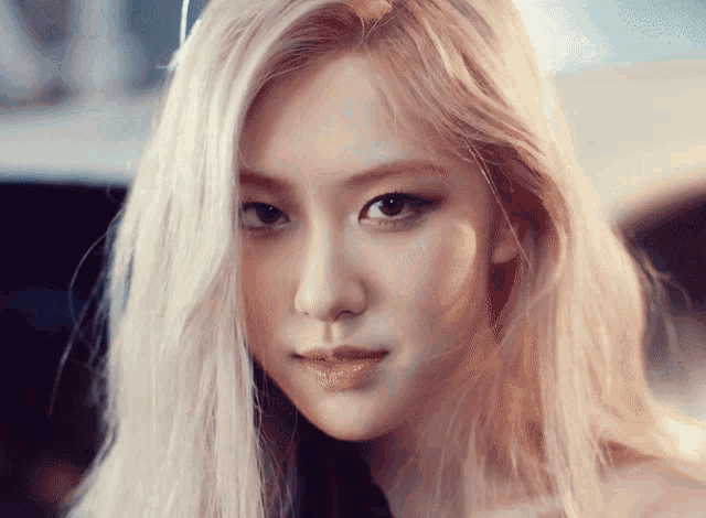 a woman with blonde hair looks at the camera