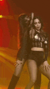 two women are dancing on a stage in front of a sign that says ' circle '