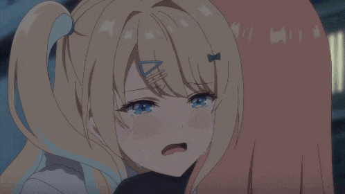 a girl with pink hair is crying while being held by another girl