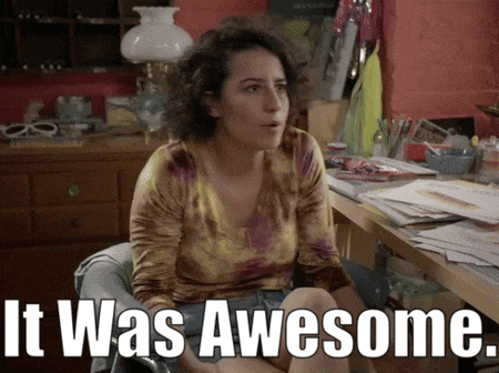 a woman sits at a desk with the words " it was awesome " behind her