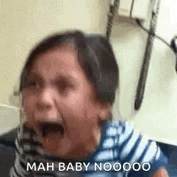a little girl is crying in a doctor 's office with her mouth wide open .