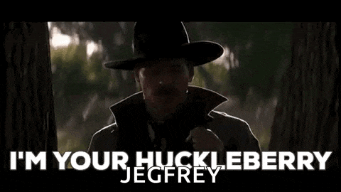 a man in a cowboy hat is standing next to a tree and talking to someone .