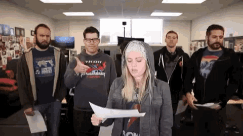 a group of people are standing around a woman holding a piece of paper that says ' sonic ' on it