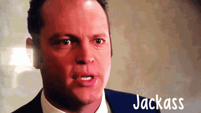 a close up of a man 's face with the word jackass written below him