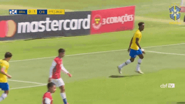 a soccer game is being played on a field and the score is 1-0