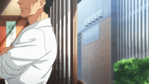 a man in a white shirt is standing in front of a building with a sign that says ' a ' on it