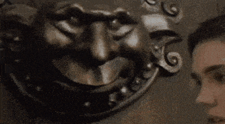 a woman is knocking on a door with a lion 's head .