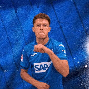 a man wearing a blue shirt with the word sap on the front