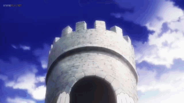 a castle tower with a blue sky in the background and the word animetv.net at the bottom
