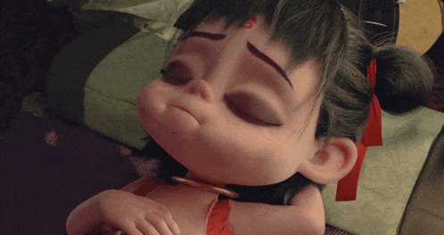 a little girl with a red ribbon around her neck is sleeping