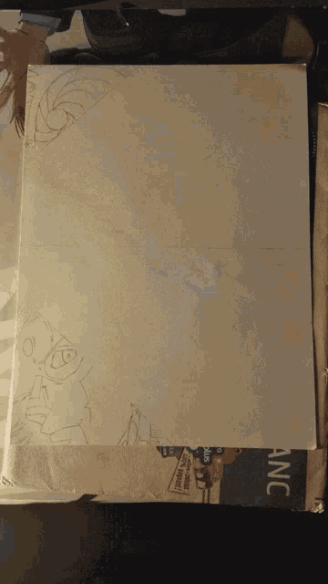 a piece of paper with a drawing on it sits on top of a box that says anc