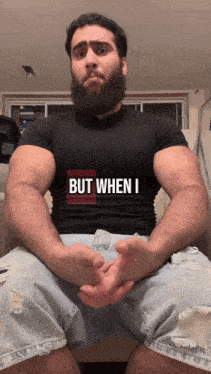 a man with a beard wears a shirt that says but when i