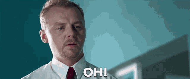 a man with a beard is wearing a white shirt and red tie .