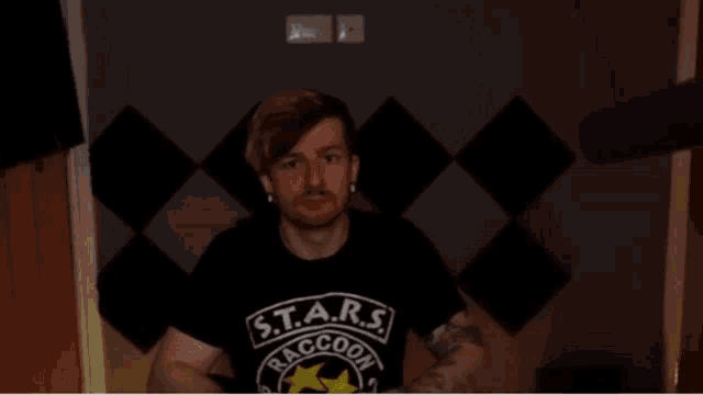 a man is wearing a black shirt that says raccoon police
