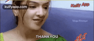 a woman in a green saree is saying thank you .