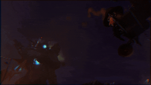 a blurry picture of a person in a dark room with fire coming out of them