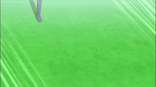 a man in a blue shirt is kicking a soccer ball on a green field
