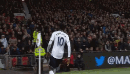 a soccer player wearing a white jersey with the number 10 on it