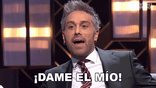 a man in a suit and tie says dame el mio in spanish
