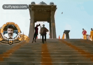 a group of people are walking down a set of stairs in front of a building .