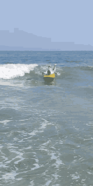 a person is riding a wave on a surfboard