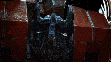 a close up of a transformer 's head with a brick wall in the background