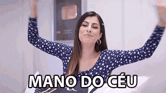 a woman is sitting on a bed with her arms outstretched and the words mano do ceu written above her .