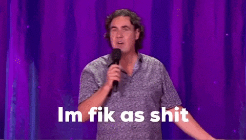 a man is holding a microphone in front of a purple curtain and says i 'm fik as shit