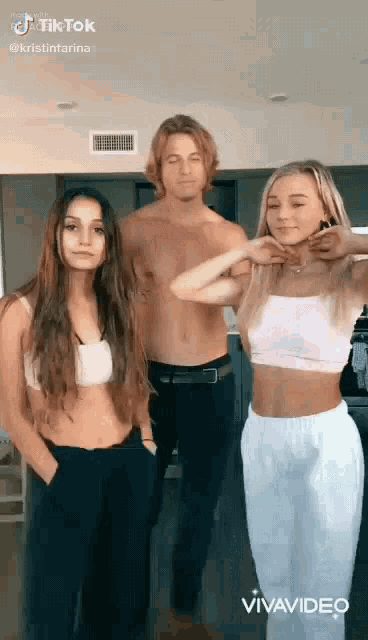 a group of people are standing next to each other in a kitchen .